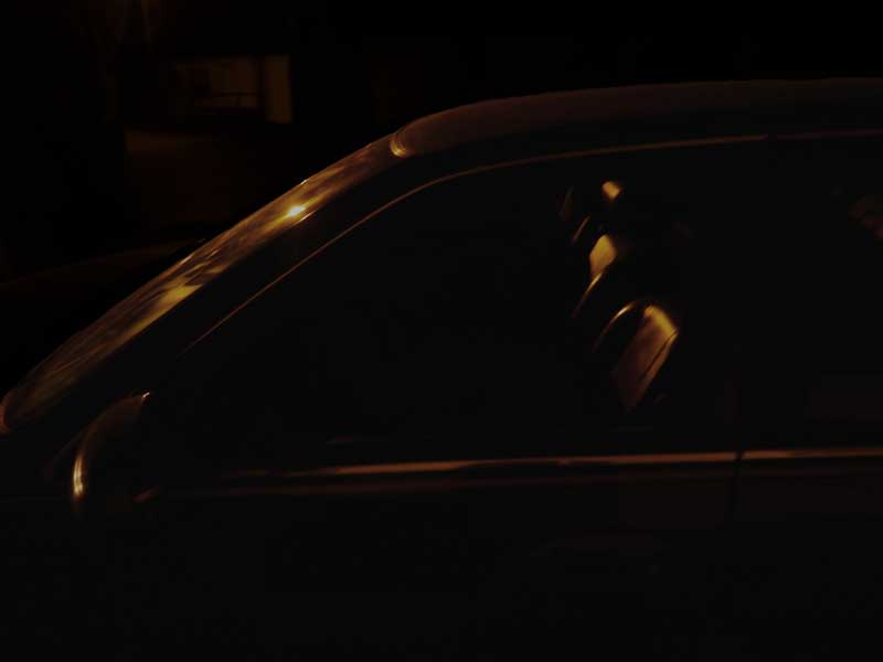 Side of a car at night.